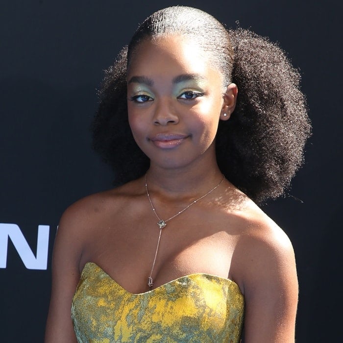 Marsai Martin complemented her look with a voluminous natural hairstyle, soft green eye makeup, and a delicate lariat necklace