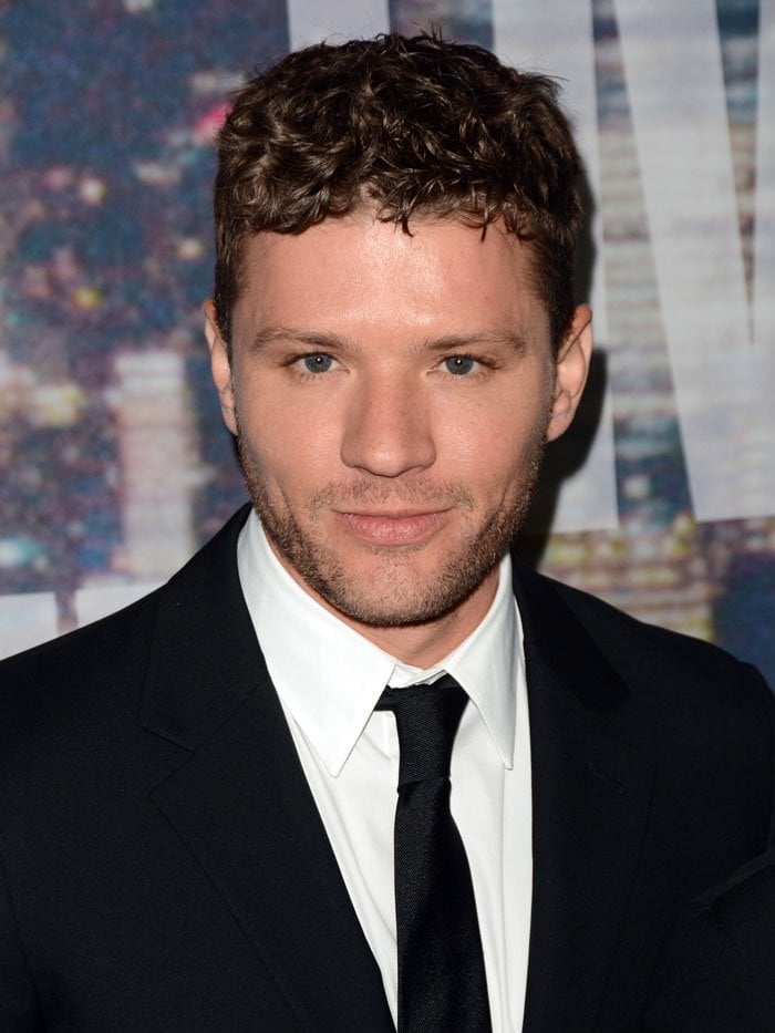 Ryan Phillippe showcasing his signature curly hairstyle and sharp black suit at the Saturday Night Live 40th Anniversary Special