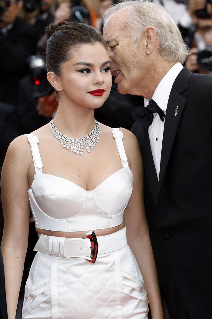 Bill Murray whispering something in Selena Gomez's ear