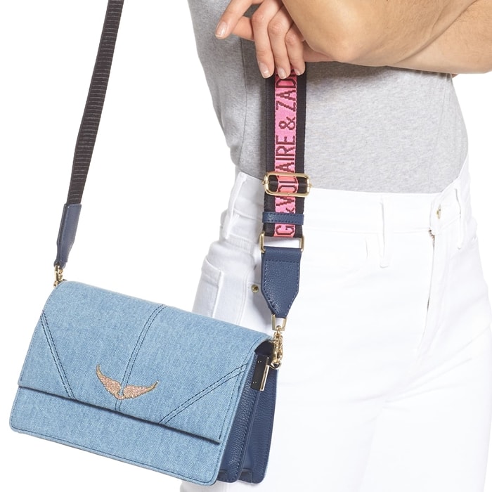 Pavé wings and a logo-embellished web strap add brand recognition to this compact structured bag made of light-wash denim