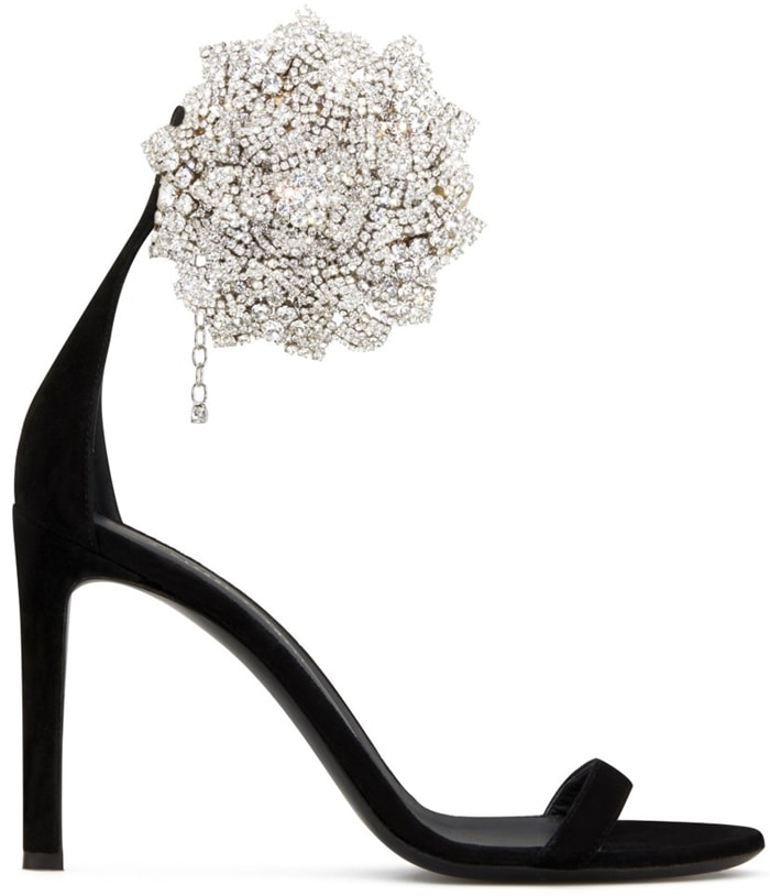 These high-heel, black suede sandals are characterized by the crystal flower accessory on the side