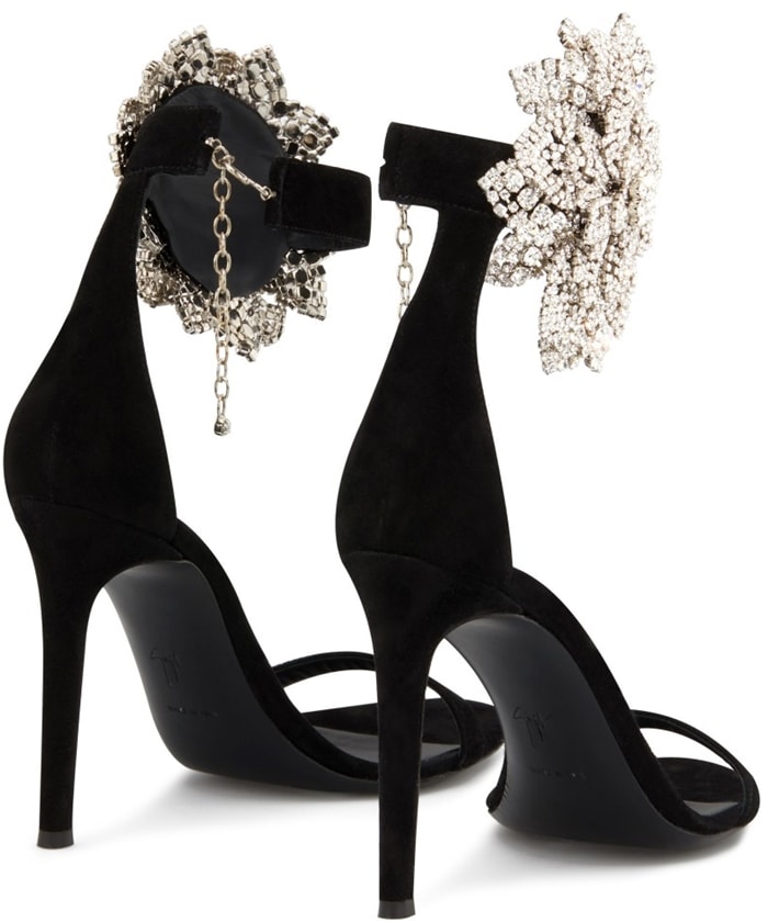 These high-heel, black suede sandals are characterized by the crystal flower accessory on the side