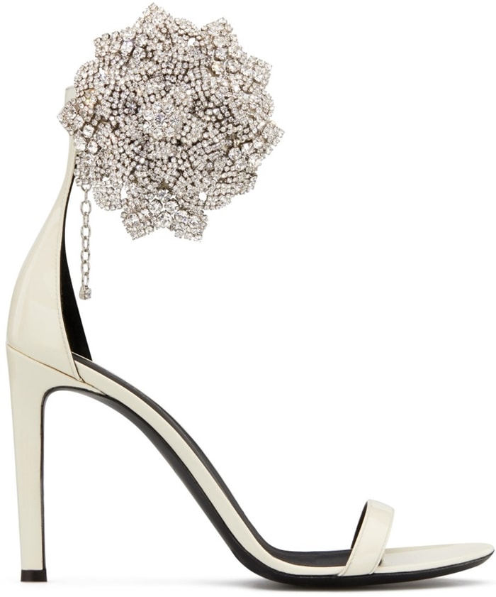 These high-heel, white patent leather sandals are characterized by the crystal flower accessory on the side