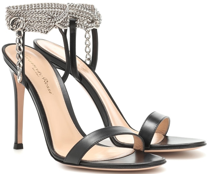 Crafted in Italy from black leather, the Debbie sandal features metallic chains around the ankle