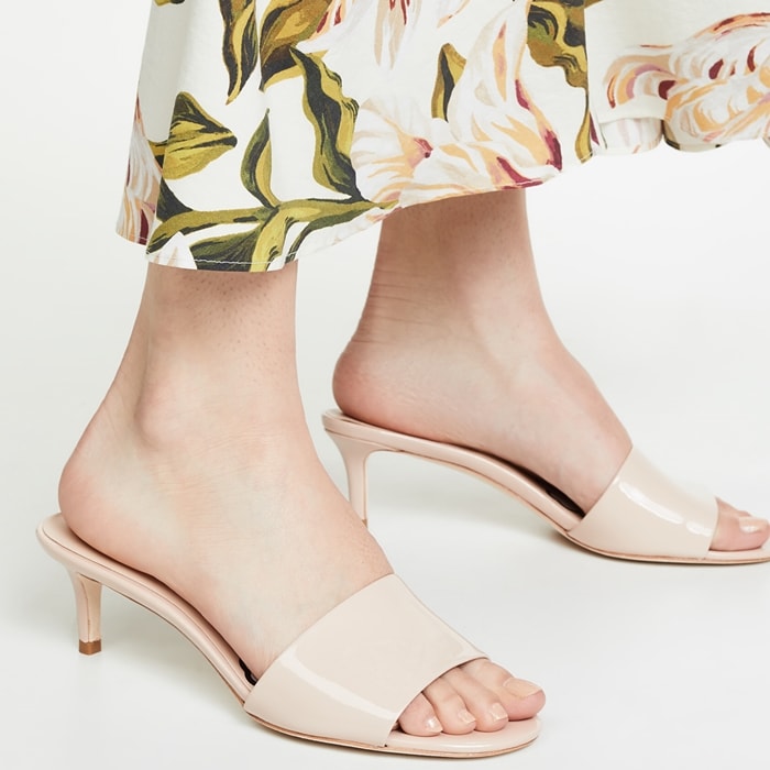 A sleek and classic kitten-heel sandal will make you smile every morning with a graphic on the footbed of a big daisy with kiss center