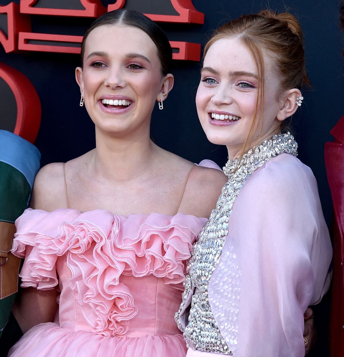Millie Bobby Brown and Sadie Sink flash their pearly white teeth on the red carpet
