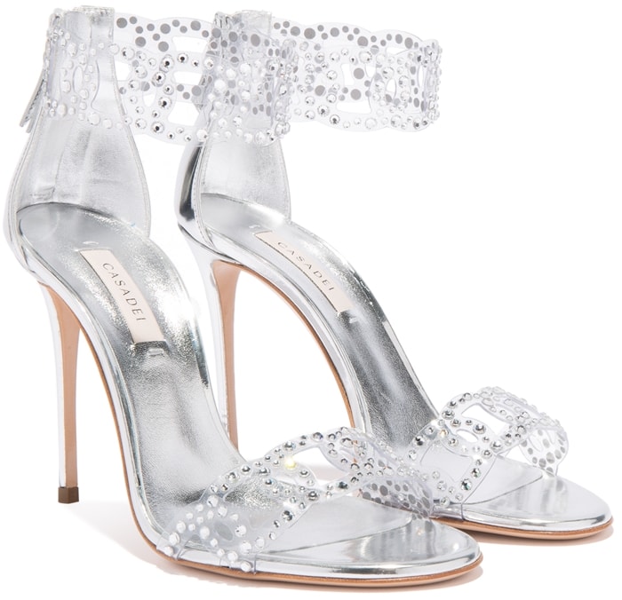 These sandals are defined by a high-tech decoration featuring laser-cut vinyl chains embellished with hot fix crystal applications, which resemble tiny water drops on the foot’s skin