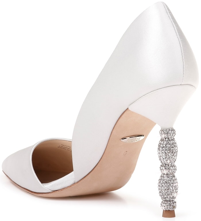 A sculptural heel featuring stacked geometric forms set with tiny pavé crystals simply dazzles on a white pointy-toe pump with a sophisticated d'Orsay silhouette