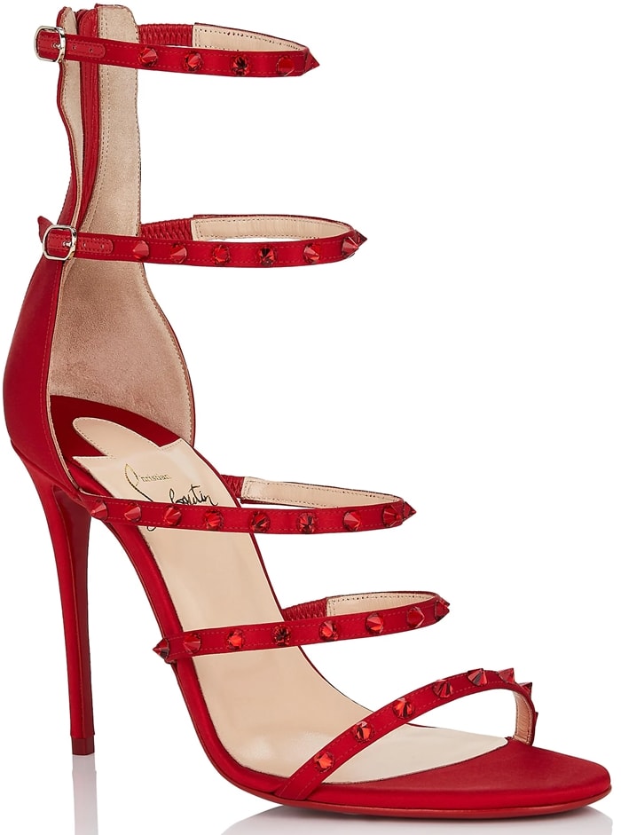Showcasing the brand's signature red leather sole, this strappy pair is completed with dazzling tonal crystal spikes