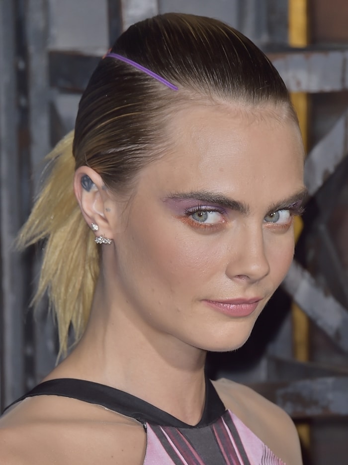 Cara Delevingne's purple-and-orange makeup and low ponytail