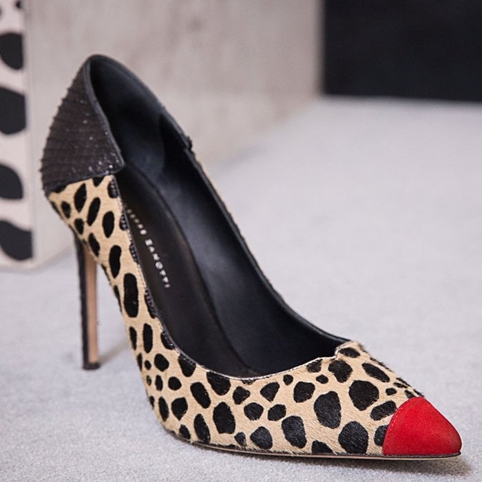 These high-heel, animal print natural pony pumps are characterized by the cocktail red suede patent insert on the front, and by the black alligator print leather insert on the back