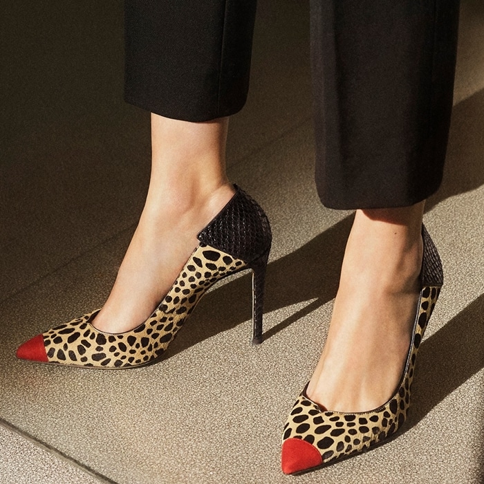 These high-heel, animal print natural pony pumps are characterized by the cocktail red suede patent insert on the front, and by the black alligator print leather insert on the back