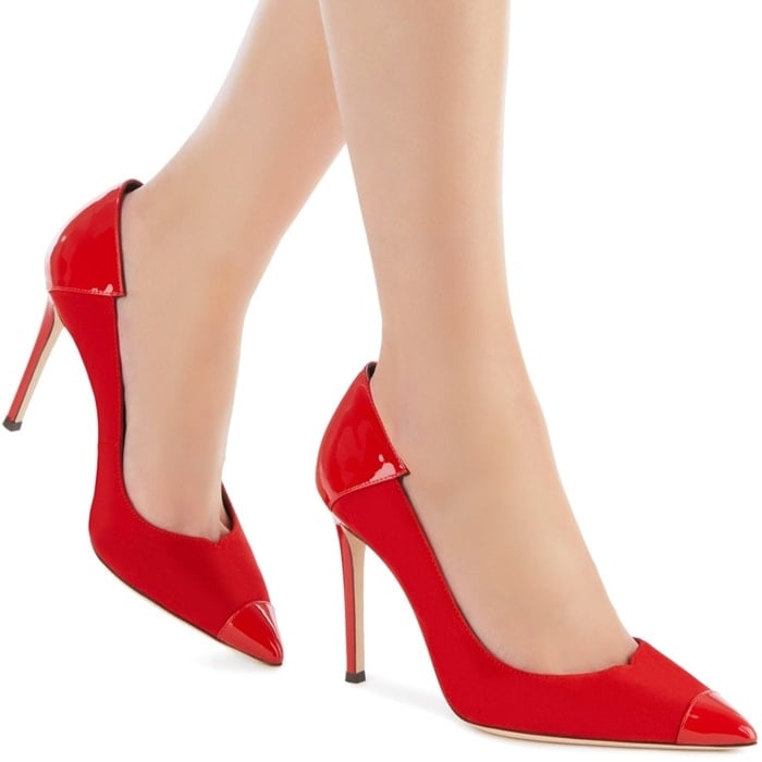 These high-heel, fire red suede pumps are characterized by poppy red patent inserts on the front and back