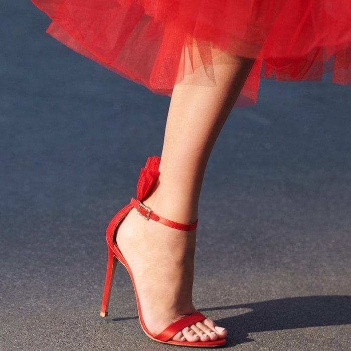 Gianvito Rossi’s red Belvedere sandals feature a plissé tulle panel that fans out above the cuff strap – an element which encapsulates the label’s experimental silhouettes