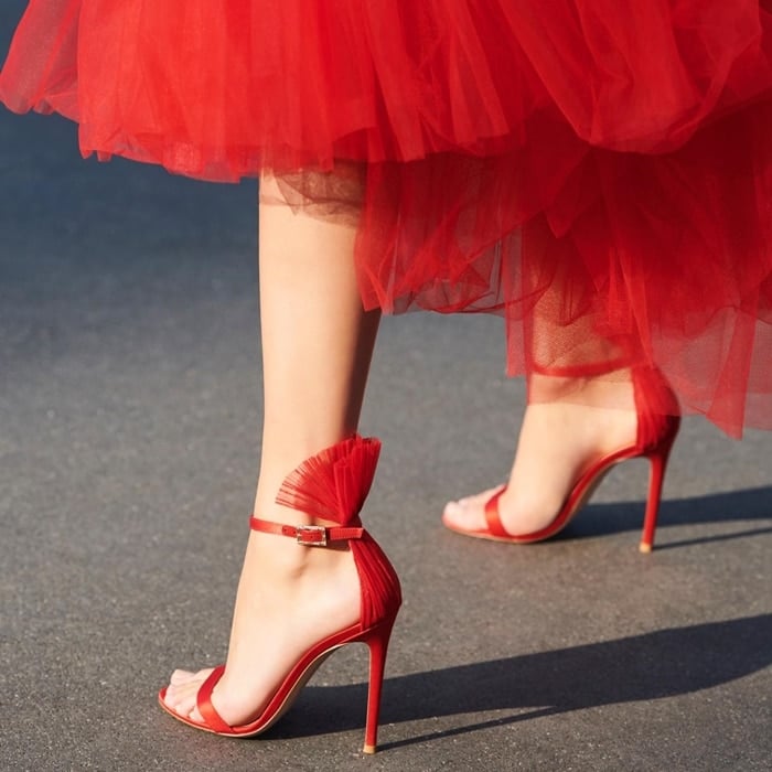 Gianvito Rossi’s red Belvedere sandals feature a plissé tulle panel that fans out above the cuff strap – an element which encapsulates the label’s experimental silhouettes