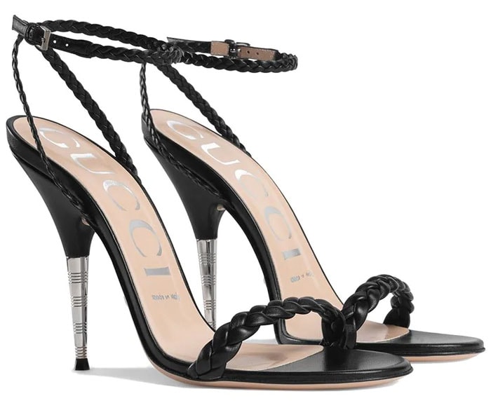 A minimalist design in black leather with braided straps and a thin heel enhanced by a textured detail in shiny metal