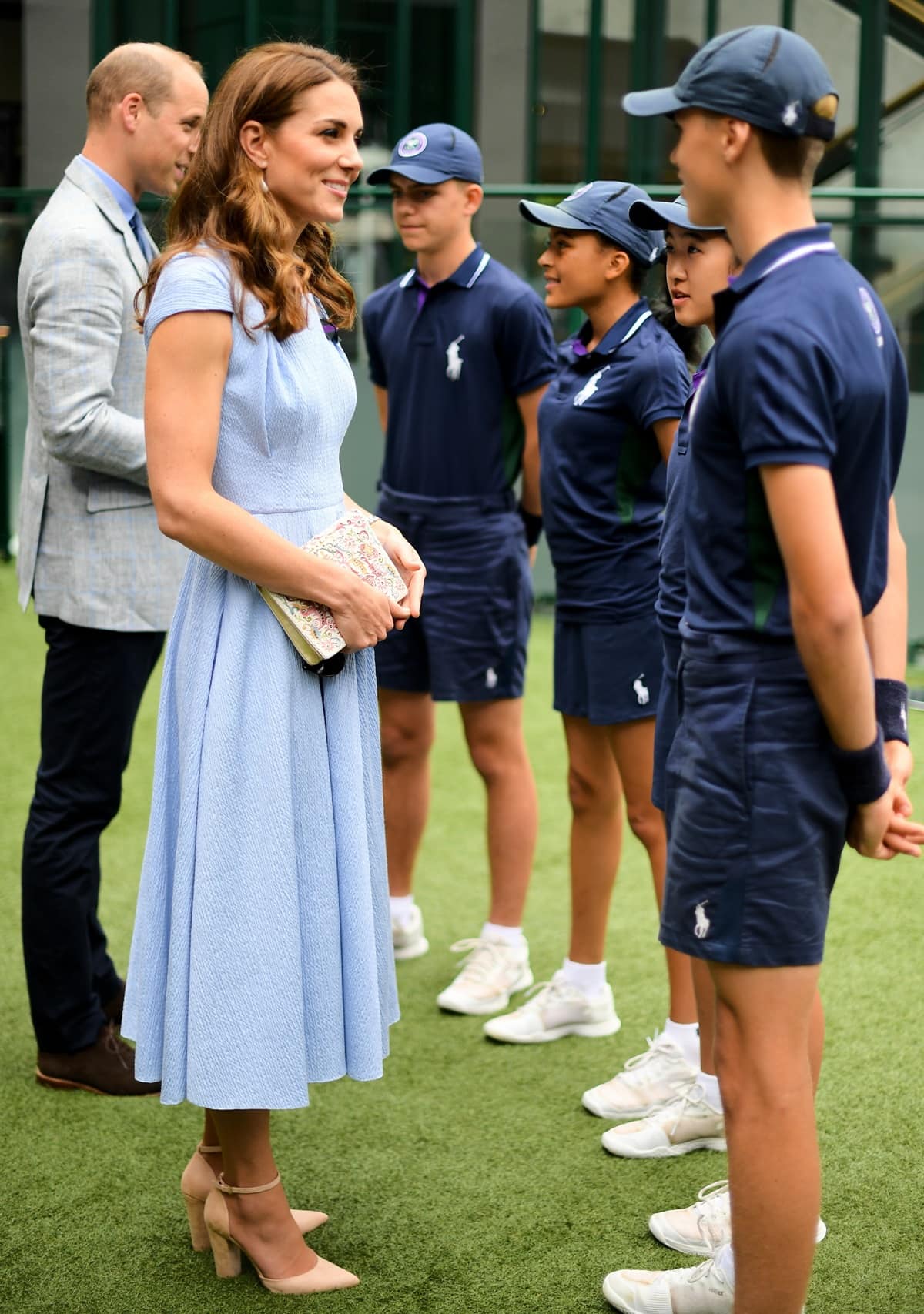 The Duchess of Cambridge looked stunning at the 2019 men's Wimbledon finals in an exquisite blue crepe ensemble by Emilia Wickstead styled with a delicate beaded white clutch and nude Aldo 'Nicholes' heels
