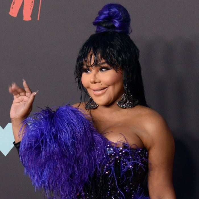 Lil' Kim's boobs almost popped out of her feathery dress
