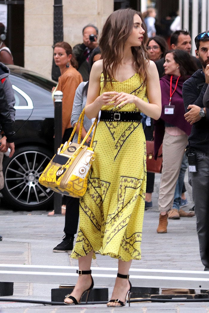 Lily Collins in a matching yellow Ganni printed top and midi skirt