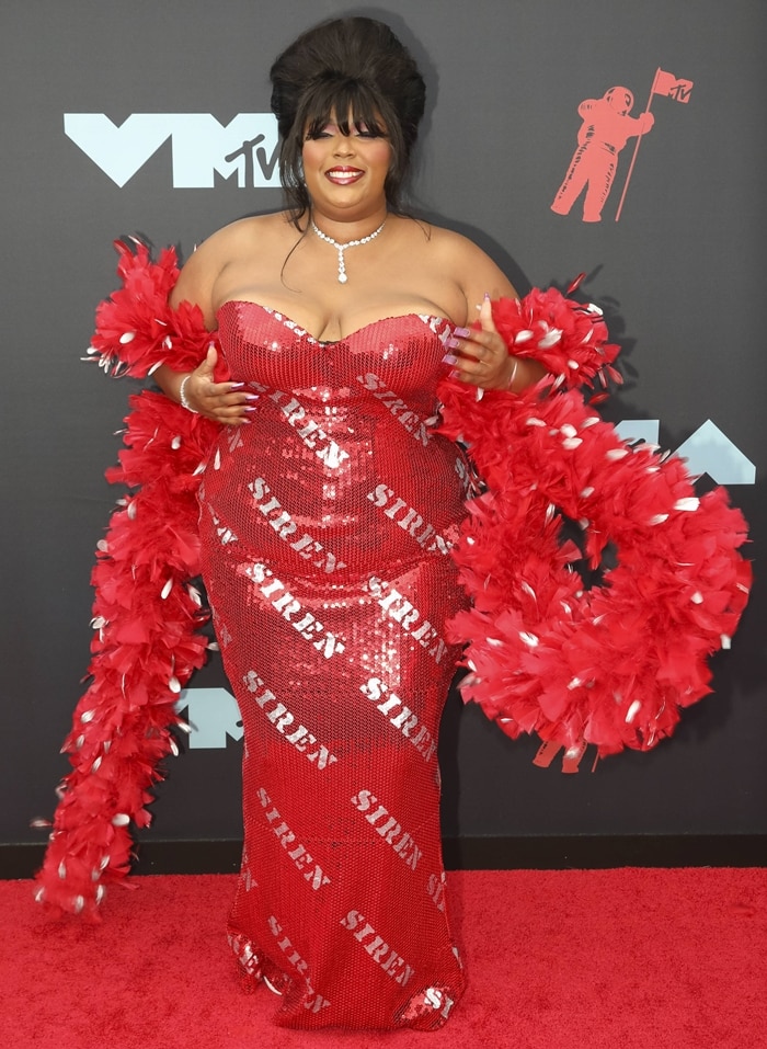 Lizzo rocked a red and metallic feather boa with a custom Moschino dress