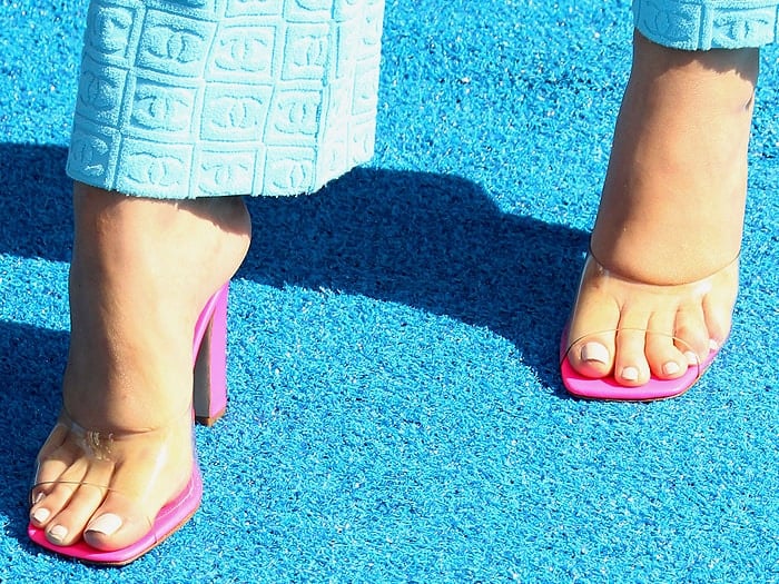 Maddie Ziegler's feet in pink clear-strap mules