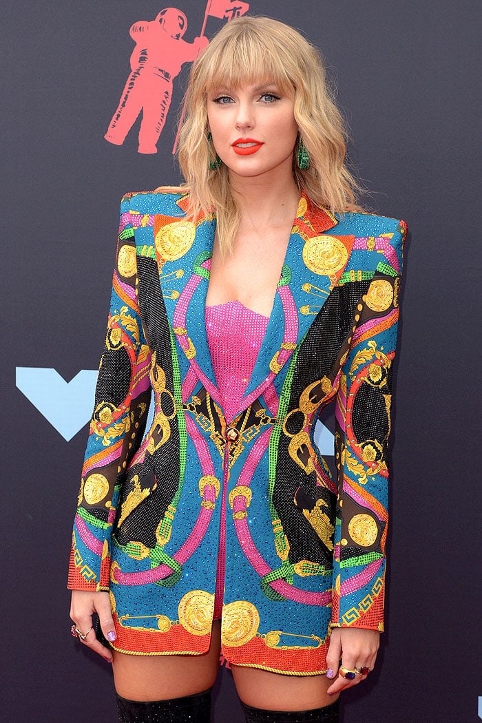 Taylor Swift in a Versace crystal-studded pink bodysuit and printed blazer dress