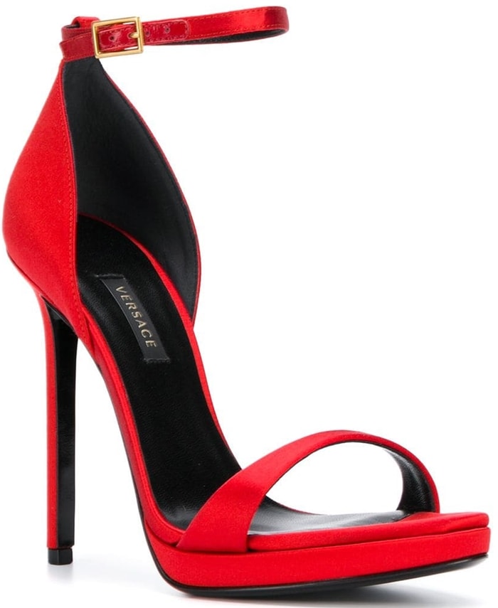 Crafted in Italy, these red leather and silk satin open toe pumps from Versace feature an open toe, a branded insole, an ankle strap with a side buckle fastening and a high heel