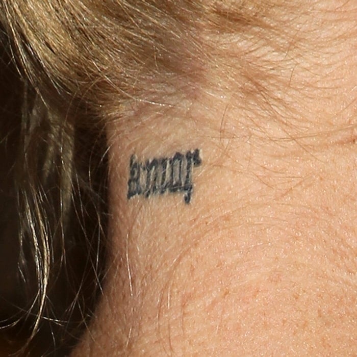 Melanie Griffith has a small "Amor" tattoo on her neck