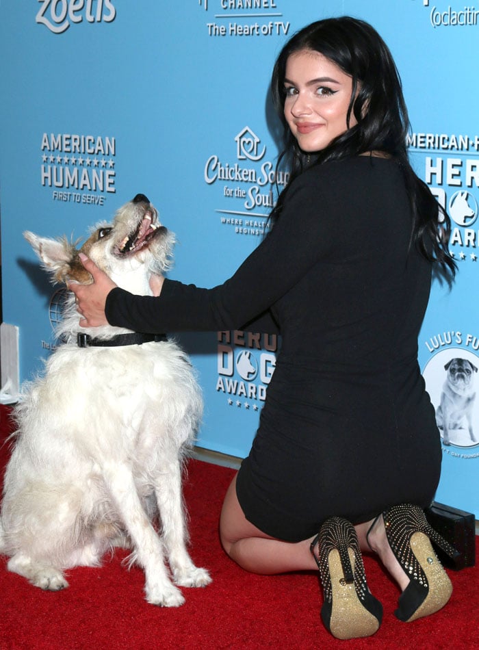 Ariel Winter petting Happy the dog at 9th Annual American Humane Hero Dog Awards