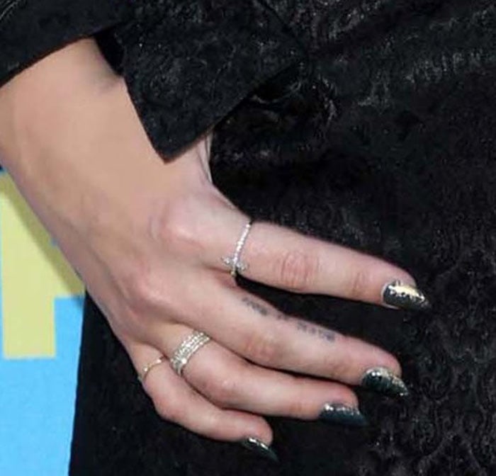 Demi Lovato's "Rock N Roll" finger tattoo