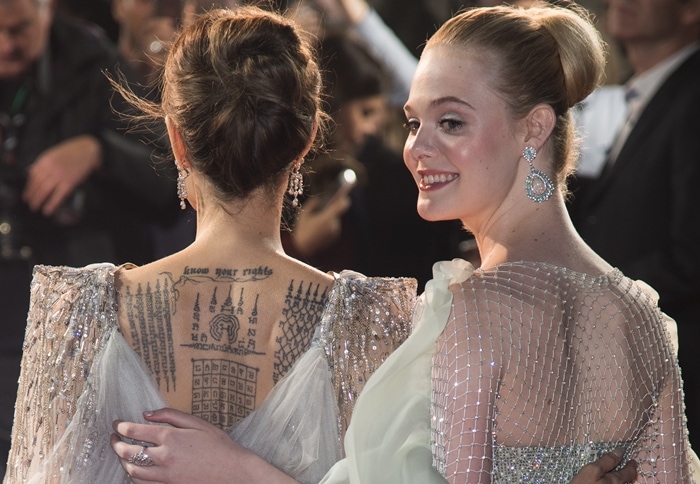 Elle Fanning admires Angelina Jolie's Yant ViHan Pha Chad Sada back tattoo