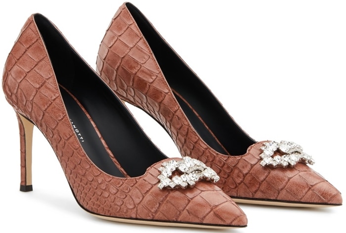 These high-heel, alligator print pumps are characterized by their vintage pink colour, and embellished by a crystal accessory on the front