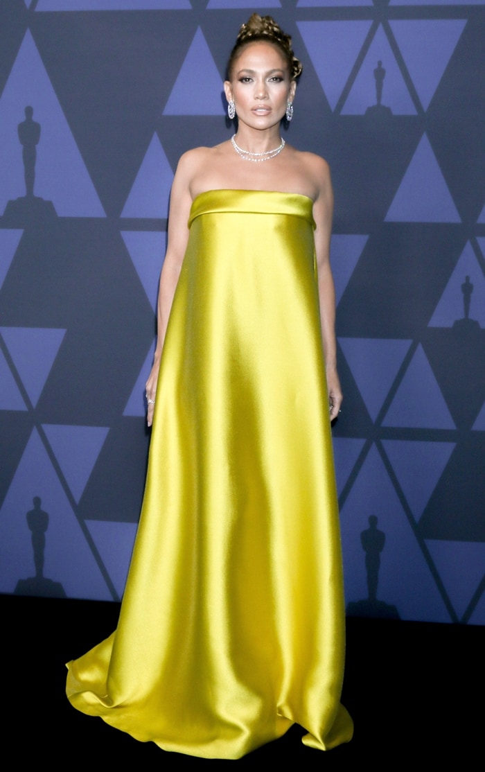 Jennifer Lopez in a strapless yellow gown on the black carpet as she arrives at the 2019 Governors Awards