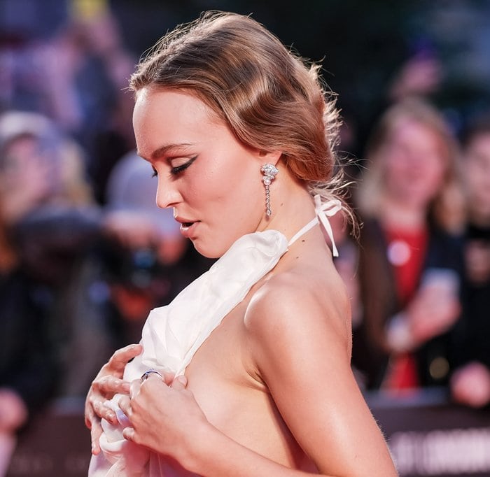 Lily-Rose Depp doing her best to prevent a nip slip wardrobe malfunction.