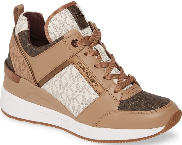 Mixed-media construction, metallic accents and a wedge heel add undeniable glamour to this sporty, street-chic sneaker