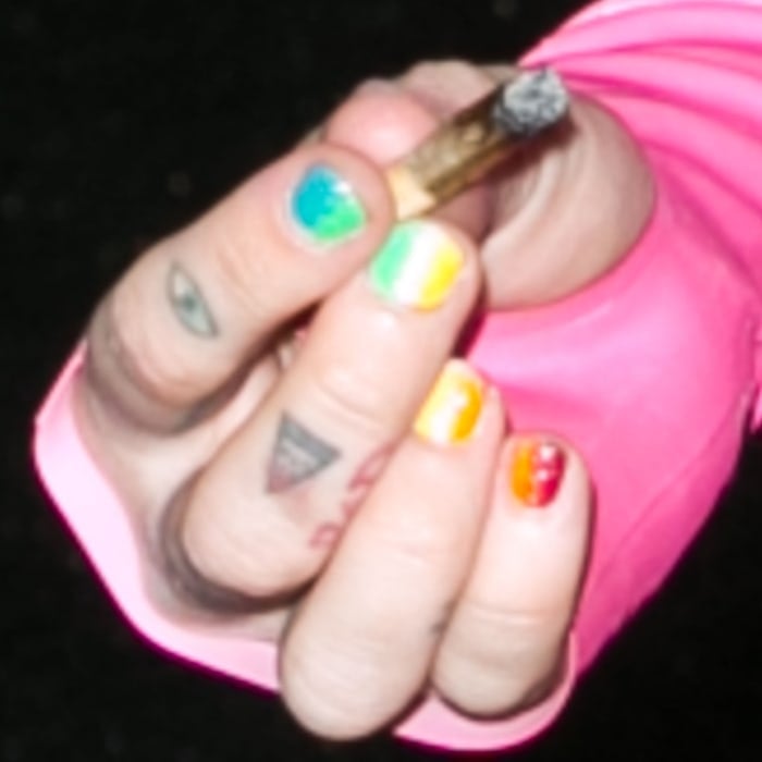 Miley Cyrus shows off her evil eye and triangle finger tattoos