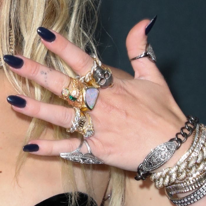 Miley Cyrus shows off her rings and body ink