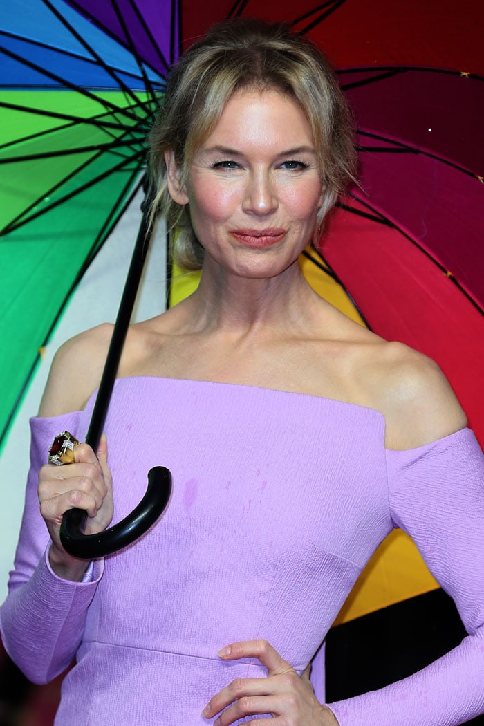 Renée Zellweger with a rainbow umbrella and a ruby ring