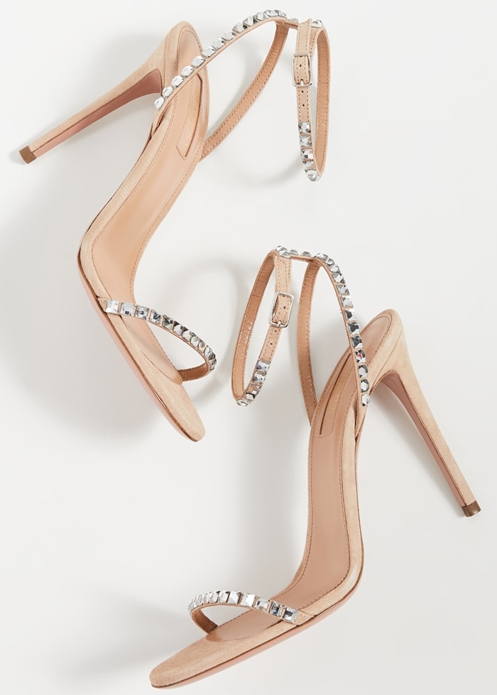 In a barely-there strappy silhouette, these nude suede sandals are accented with sparkling crystal trim