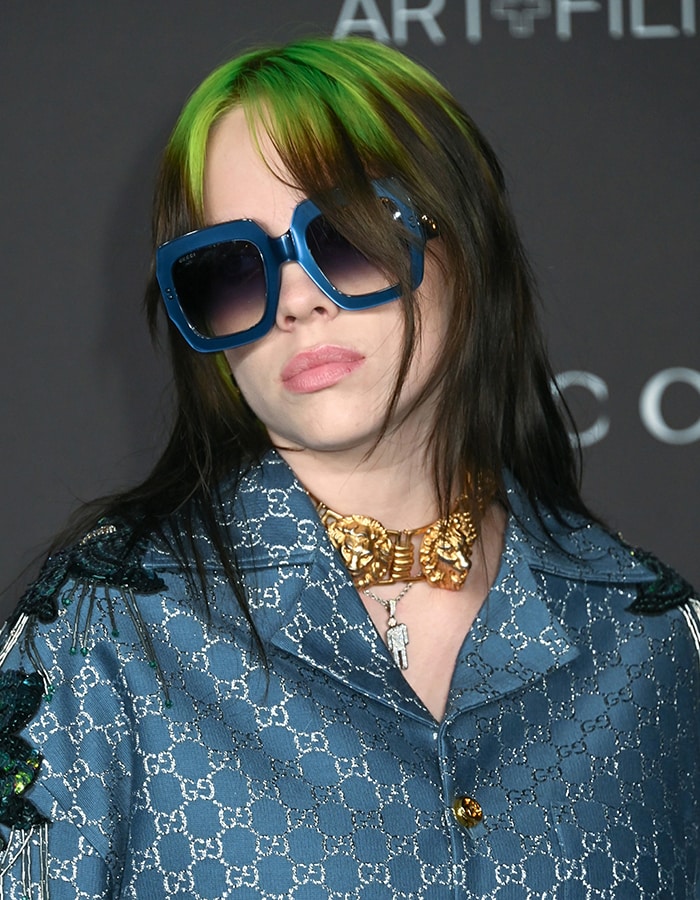 Billie Eilish wears her green and black accidental mullet