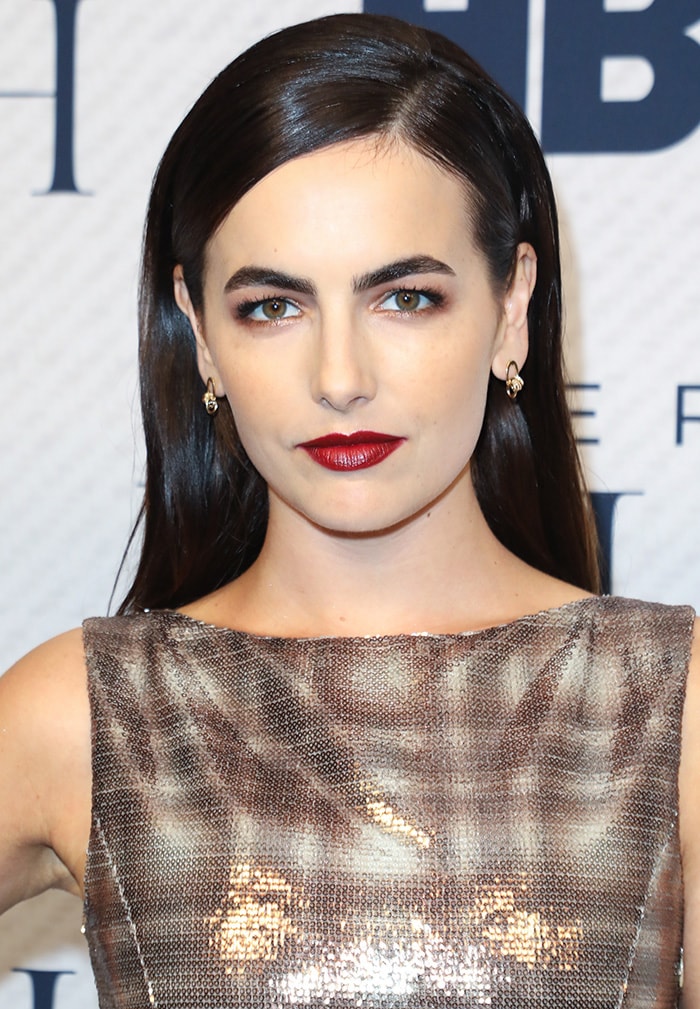 Camilla Belle wears '60s beehive hairstyle with bold red lipstick