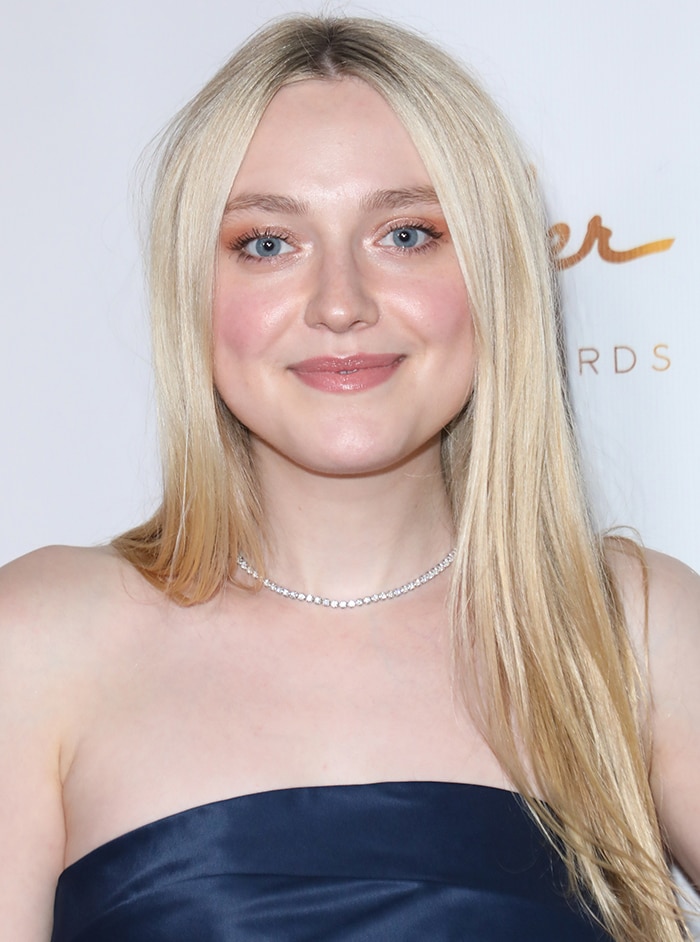 Dakota Fanning keeps an elegant look with center-parted hairstyle and soft makeup