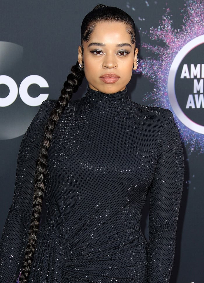 Ella Mai wears a braided ponytail with winged eyeliner and subtle smoky eyeshadow