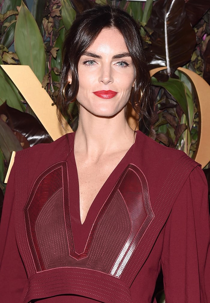 Hilary Rhoda wears bold red lipstick to match her dress