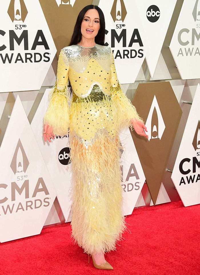 Kacey Musgraves dons a striking yellow sequined dress by Valentino