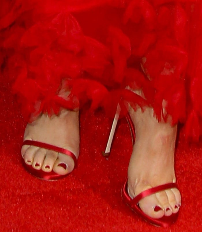 Katherine Langford shows off her red pedicure in matching Stuart Weitzman heels