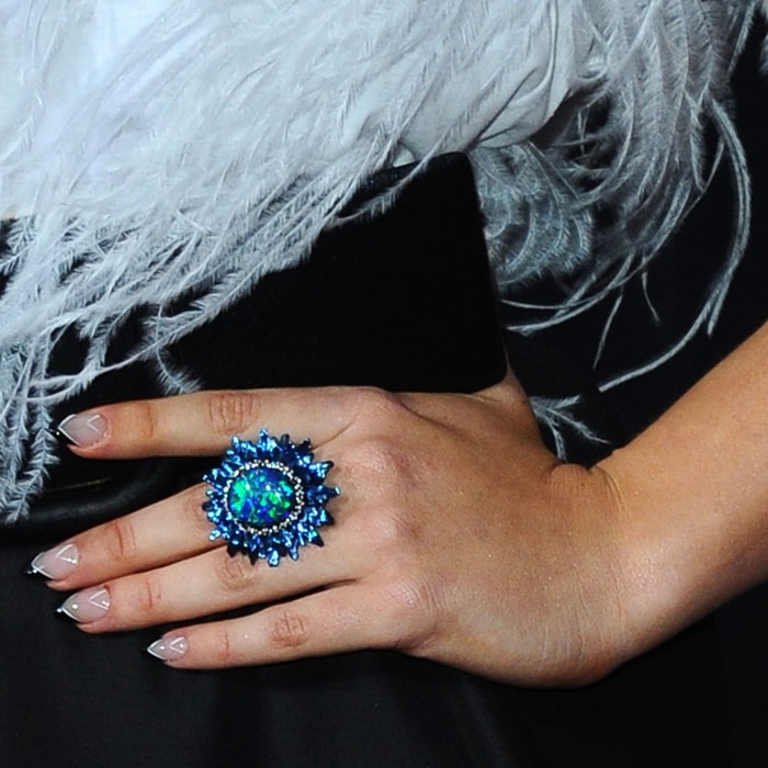 Katherine Langford's Chopard ring featuring a 19.93-carats oval-shaped opal, .74-carats of tsavorites, .42-carats of sapphires, .39-carats of colored diamonds, .19-carats of diamonds, and .09-carats of lazulites in 18k white gold and titanium from the Fleur d’Opales Collection