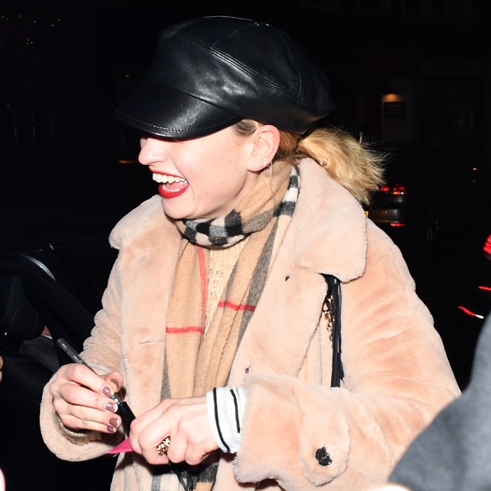 Lily James combining casual and chic with a Burberry scarf and baker boy cap in London, 2019