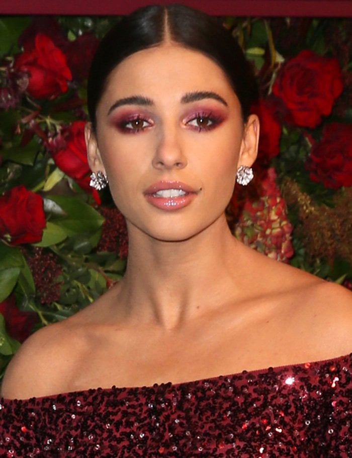 Naomi Scott wears coordinating rogue smoky eye-makeup