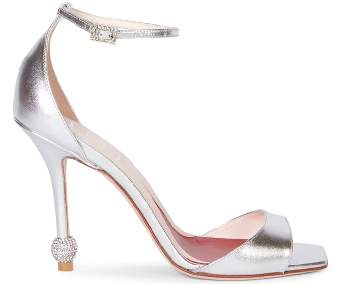 These shapely sandals sparkle with a matching crystal buckle and heel accent
